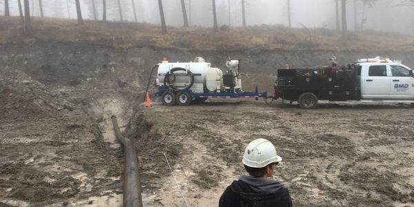 Horizontal Directional Drill pulling water main under hillside