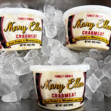 Three containers of Mary Ellen Crabmeat on ice.