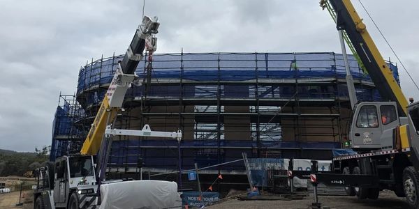 Construction site with cranes and scaffolding.