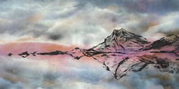 A serene mountain landscape reflected in calm water under a cloudy sky.