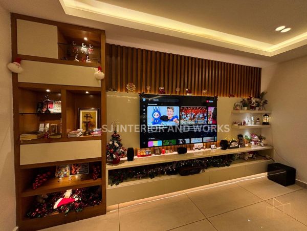 Modern living room entertainment unit with warm lighting and Christmas decorations.