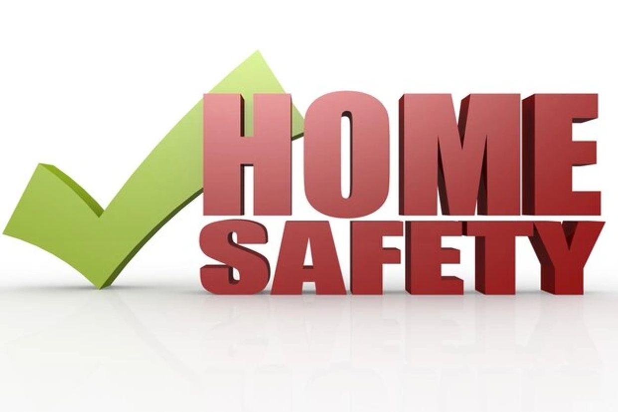 3D text 'HOME SAFETY' with a large green check mark behind it.