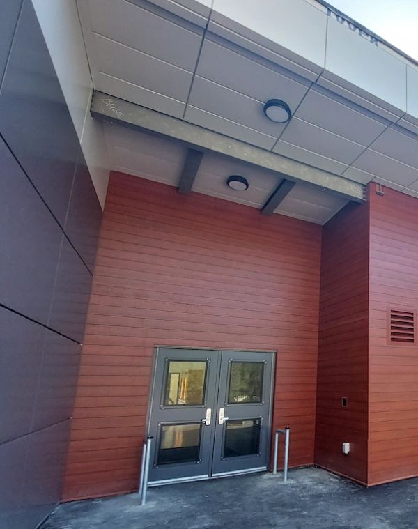 Modern double door entrance with red paneling.