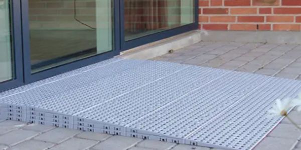 Threshold metal ramp leading to glass door.