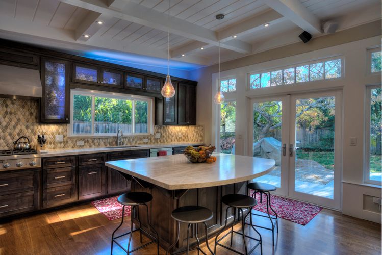 remodeled kitchen, custom cabinets, tile backsplash with marble top island and french doors