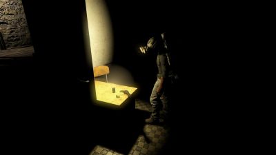Person illuminated by a light in a dark room.