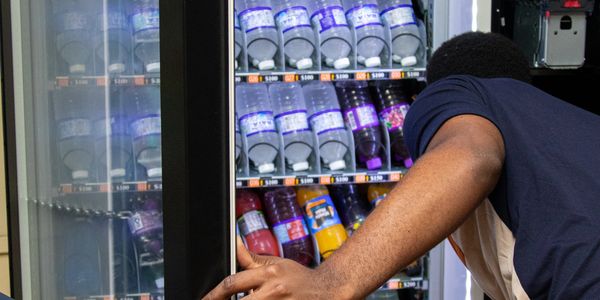 Staff servicing one of our vending machines