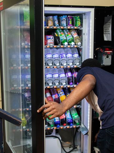 Vendzerrz staff repairing vending machine