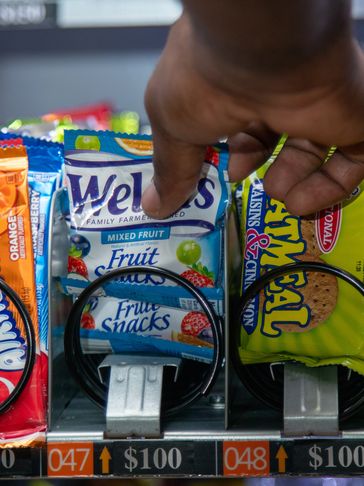 Staff stocking dedicated snack vending machine