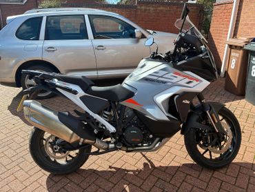 A KTM 1290 Super Adventure motorcycle parked on a driveway.