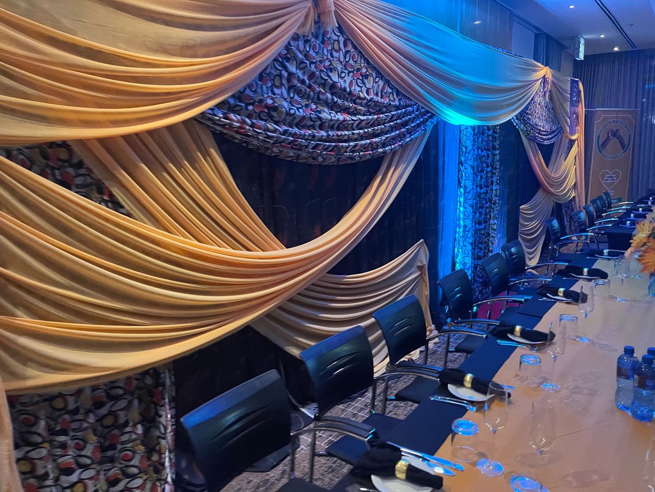 Elegant meeting setup with draped fabric and arranged chairs.