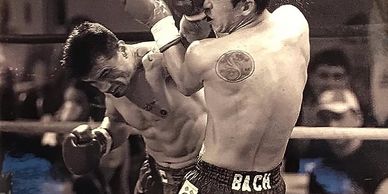 Two boxers engaged in a fierce match inside the ring.