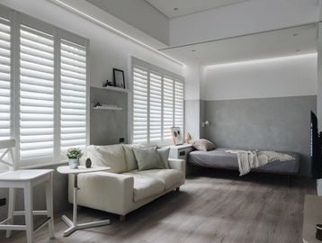 Modern minimalist living room and bedroom with neutral tones and natural light.