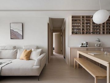 Minimalist living and dining area with neutral tones and clean lines.
