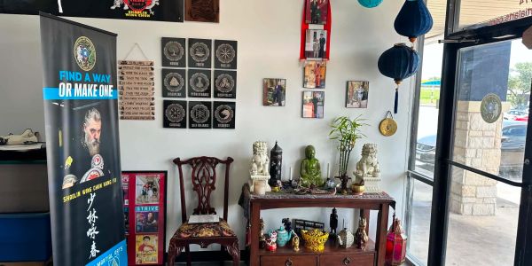 Interior corner of a martial arts school with decorations and banners.