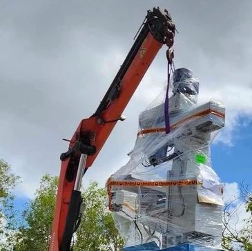 Crane lifting heavy machinery. 