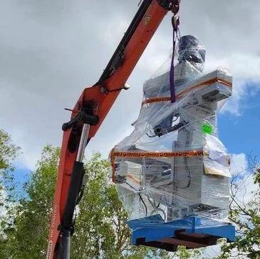 Crane lifting heavy machinery. 