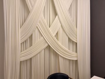 Image shows ivory drapery backdrop available for rent in midland texas 