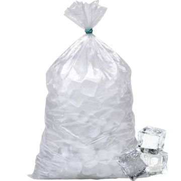 Large plastic bag filled with ice cubes and some loose cubes beside it.