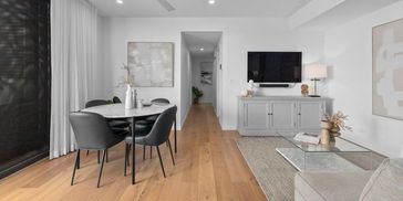 Modern living room and dining area with minimalist design.