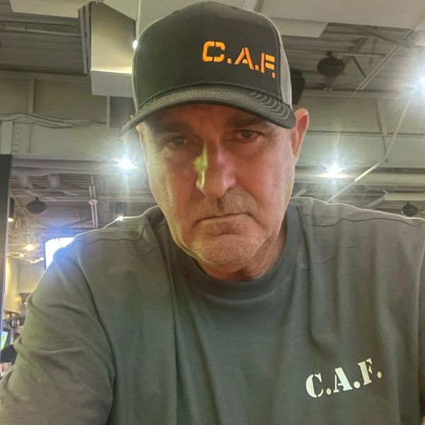Kenny MF'n Jones in Orange on black CAF embroidered  hat and white print on gray shirt