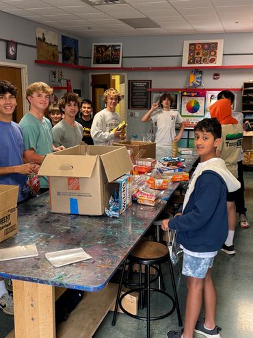 Putting together donated supplies to make snack packs for underprivileged youth in our area. 