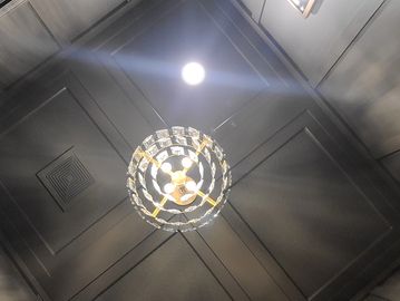 Decorative ceiling light with mirror and dark paneling.