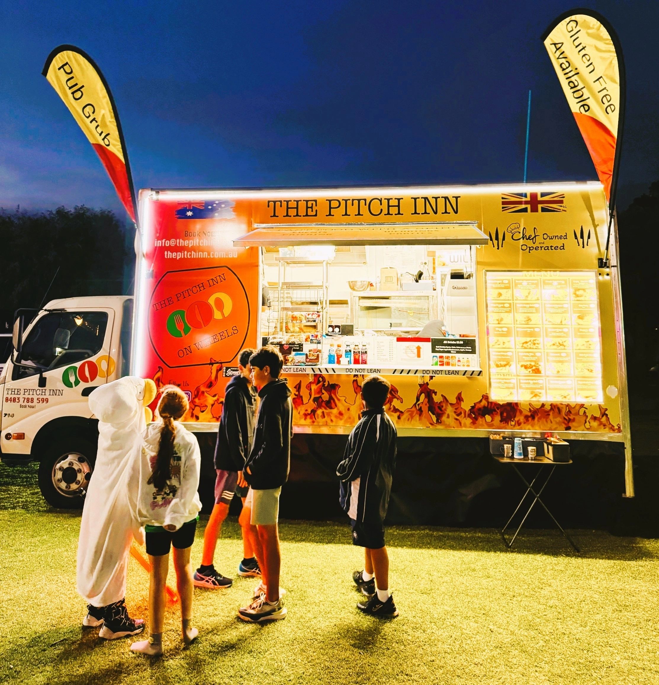Waiters presenting gourmet dishes in a restaurant setting.