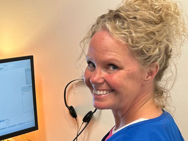 Audiologist testing a person's hearing.
