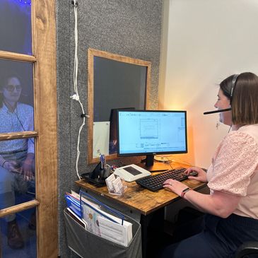 Audiologist testing a man's hearing.