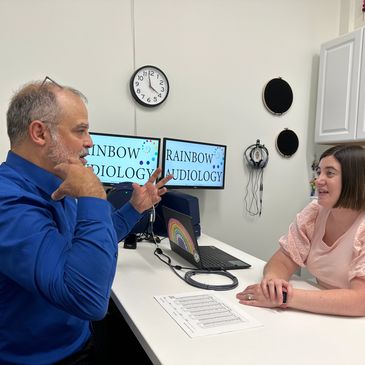 Man discussing hearing loss with an audiologist.