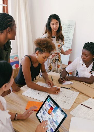 A culturally diverse group of woman planning at a table. 