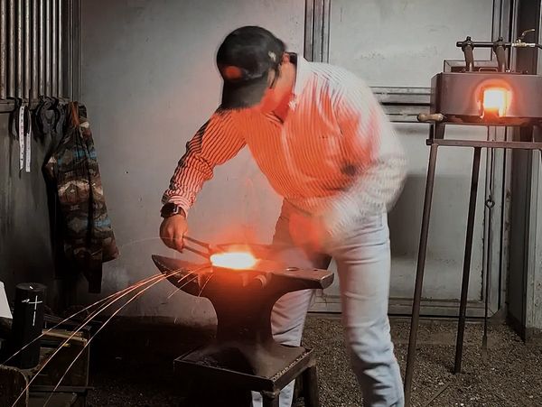Custom shoes being forged by the farrier.