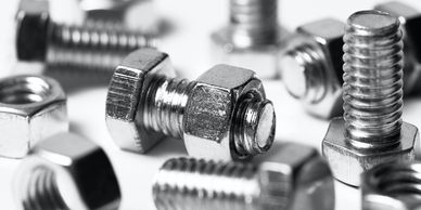 A collection of M10 bolts and nuts. The nuts are screwed on to the bolts. Plain white background. 