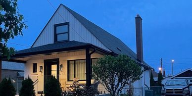 A cozy house with lights on during twilight.