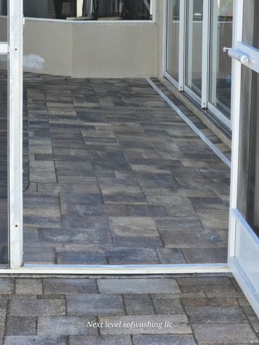 Clean tiled patio and entrance area with sliding glass doors.