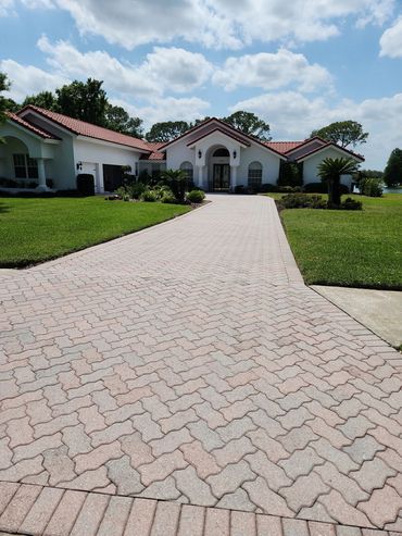 White house with red roof and paved driveway