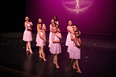 lyrical dancers posed and smiling onstage