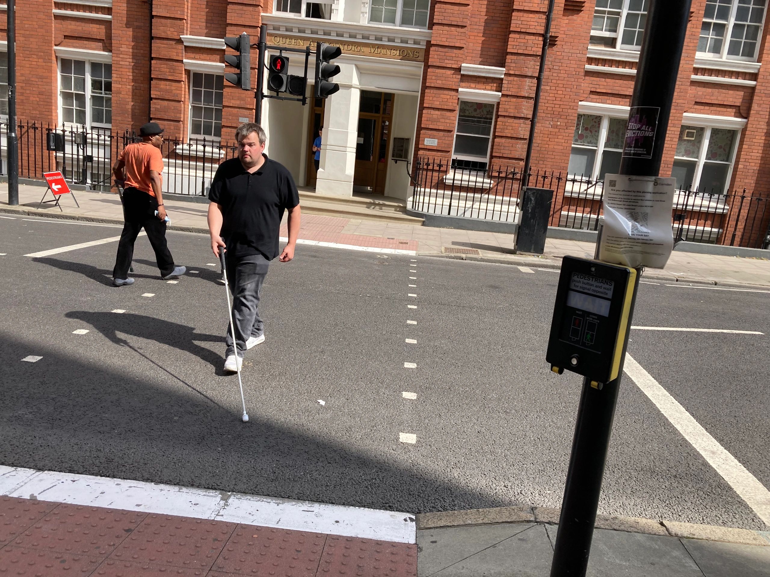 Long cane user crossing a road