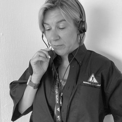image of V I Safety colleague wearing a head set taking  a call