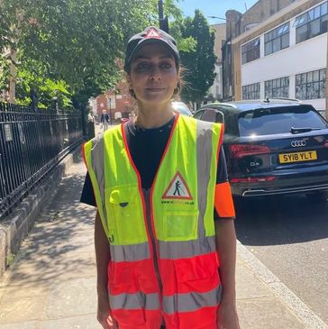 Picture of one of our amazing and valuable volunteers smiling wearing a  high Vis Vest