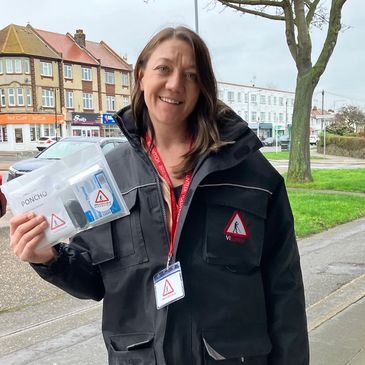 Picture of Jenny our regional Exhibition events manager smiling & holding one of our packs.