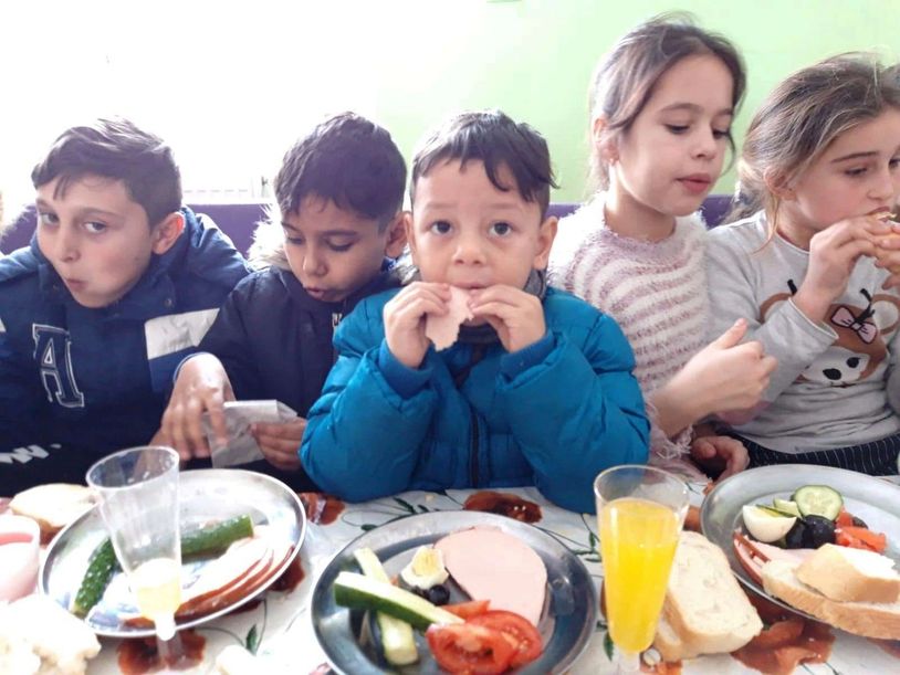 Group of children eating at table