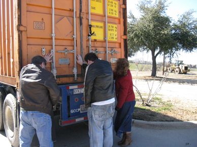 a group of people looking at the back of a truck