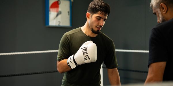 Boxer training intensely in the ring.