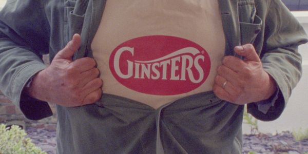 Person revealing Ginsters logo on shirt.