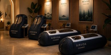 Modern wellness center with Airvida chambers and relaxation pods in a warm, inviting space.