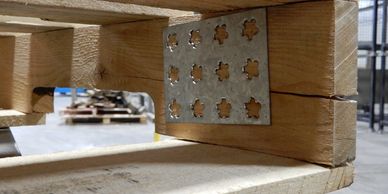 Damaged wooden pallet being repaired
