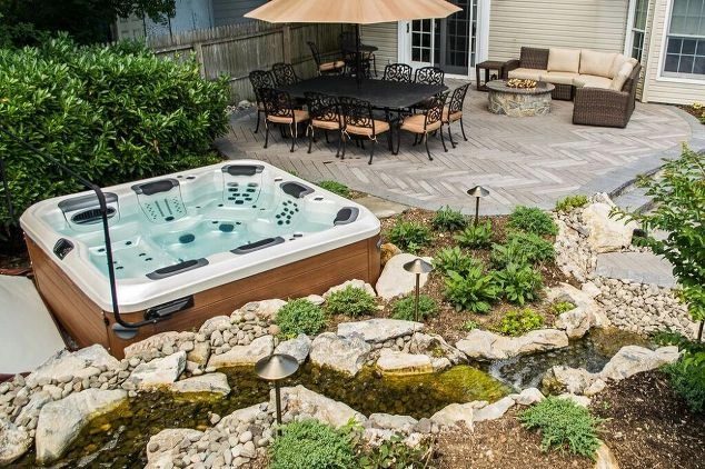 Hot tub installed with stone surround at a Long Island home