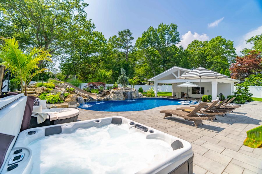 Pool and spa with stone surround at a Long Island residence